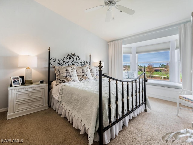 bedroom featuring ceiling fan, carpet floors, and lofted ceiling