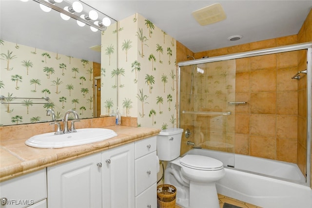 full bathroom with tile patterned floors, vanity, toilet, and bath / shower combo with glass door