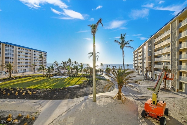 view of community with a water view and a lawn