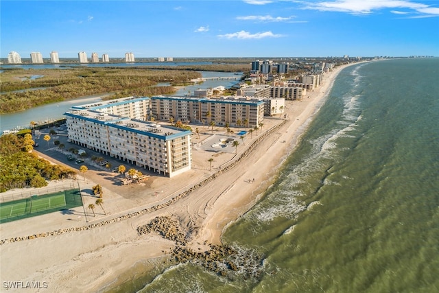 aerial view with a water view and a beach view