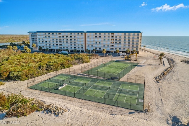 drone / aerial view with a beach view and a water view