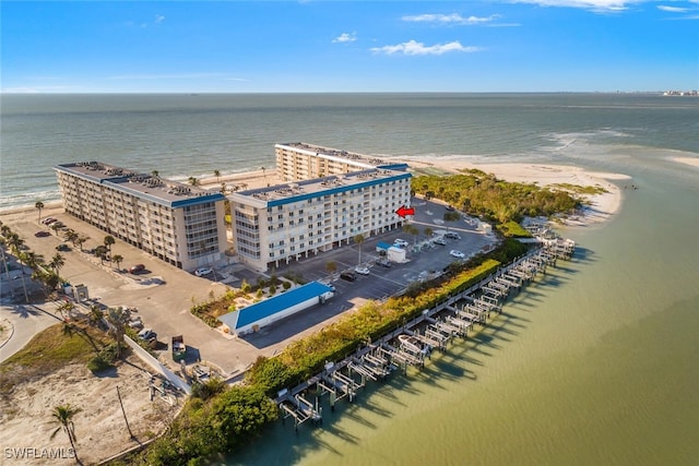 birds eye view of property featuring a water view and a beach view