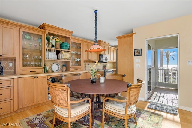 dining space with light hardwood / wood-style floors