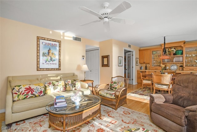 living room featuring ceiling fan and light wood-type flooring