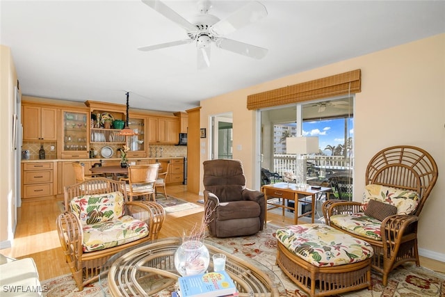 living room featuring ceiling fan and light hardwood / wood-style floors