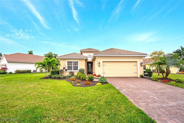 mediterranean / spanish house with a garage and a front yard