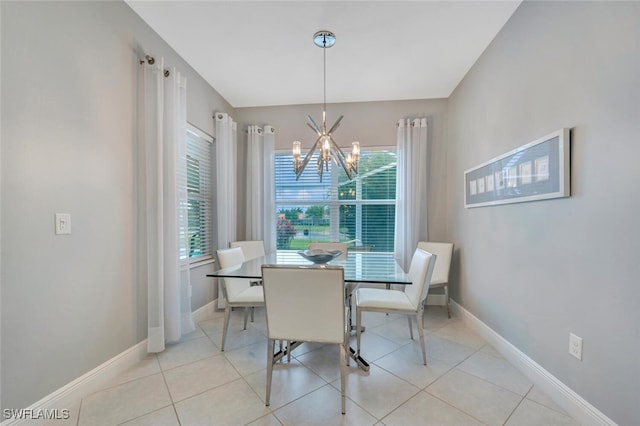 tiled dining space with plenty of natural light and a notable chandelier