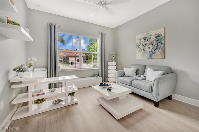 living room featuring ceiling fan and light hardwood / wood-style flooring