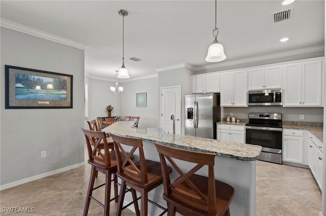 kitchen featuring a breakfast bar, appliances with stainless steel finishes, hanging light fixtures, a center island, and white cabinets