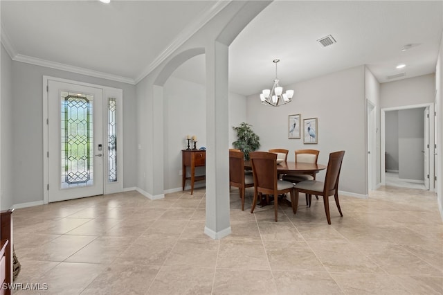 entrance foyer with crown molding, light tile patterned flooring, and an inviting chandelier