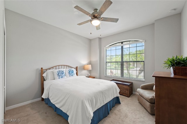 bedroom with light colored carpet and ceiling fan