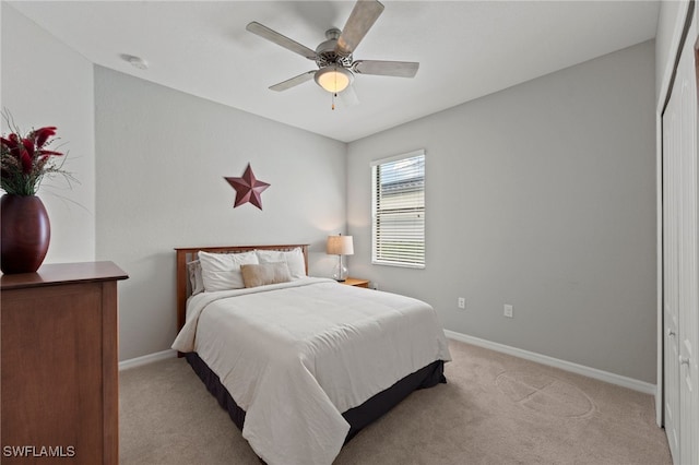 bedroom featuring light carpet, a closet, and ceiling fan