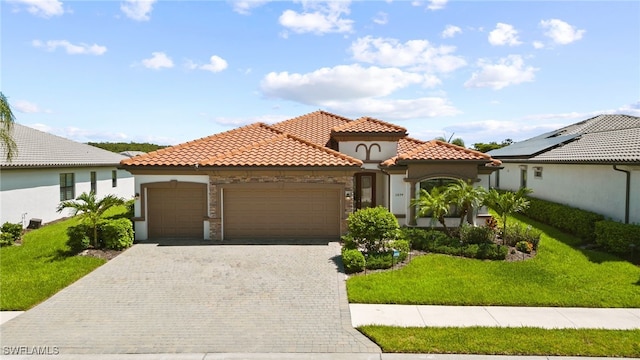 mediterranean / spanish house with a front yard and a garage