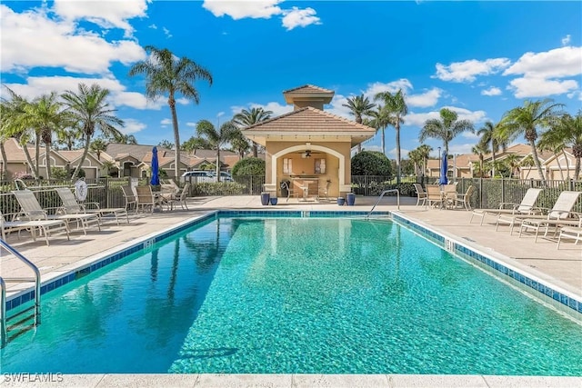 view of pool featuring ceiling fan and a patio