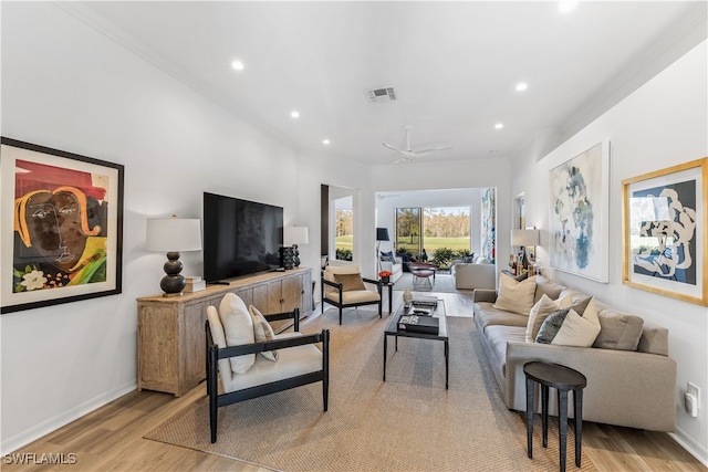 living room featuring ceiling fan and light hardwood / wood-style floors