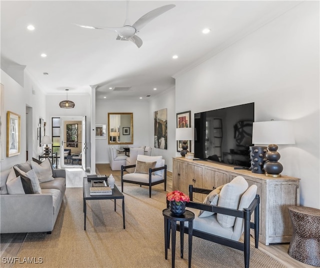 carpeted living room with ceiling fan and ornamental molding