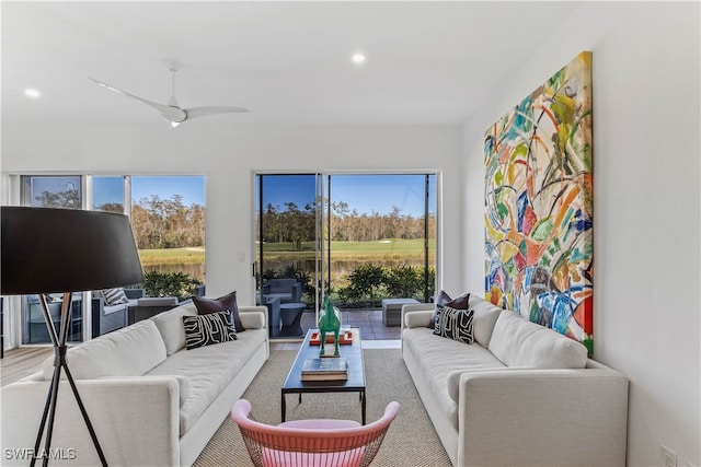 living room with plenty of natural light and ceiling fan