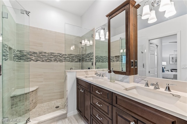 bathroom featuring vanity and tiled shower