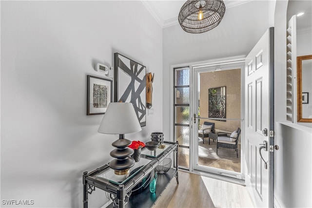 entryway featuring light hardwood / wood-style floors and crown molding