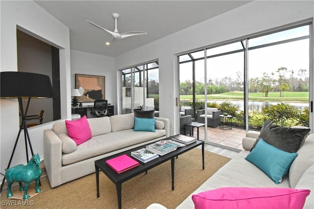 sunroom / solarium with a water view and a ceiling fan