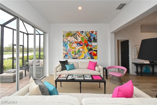 tiled living room featuring recessed lighting and visible vents