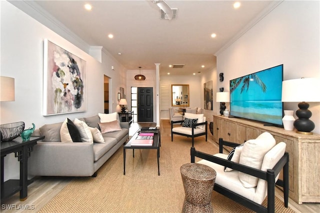 living room with ornamental molding, visible vents, and recessed lighting