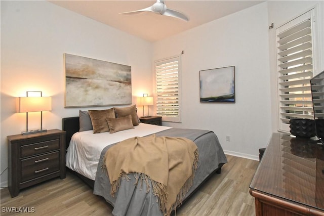 bedroom featuring light wood-type flooring, ceiling fan, and baseboards