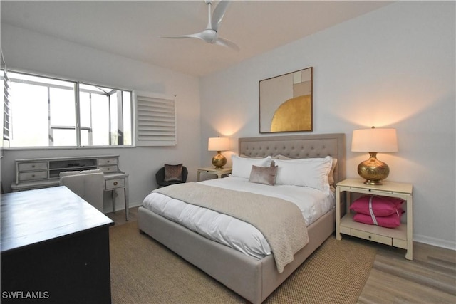 bedroom featuring a ceiling fan, baseboards, and wood finished floors