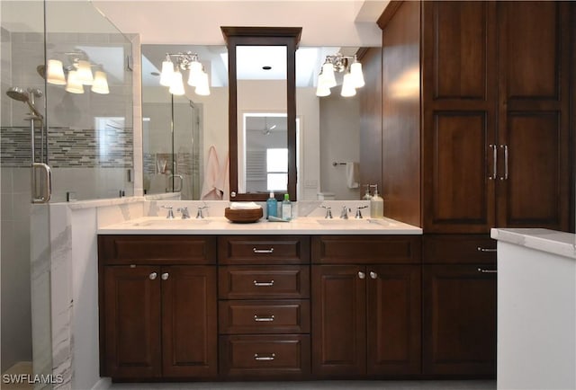 full bathroom with double vanity, a stall shower, toilet, and a sink