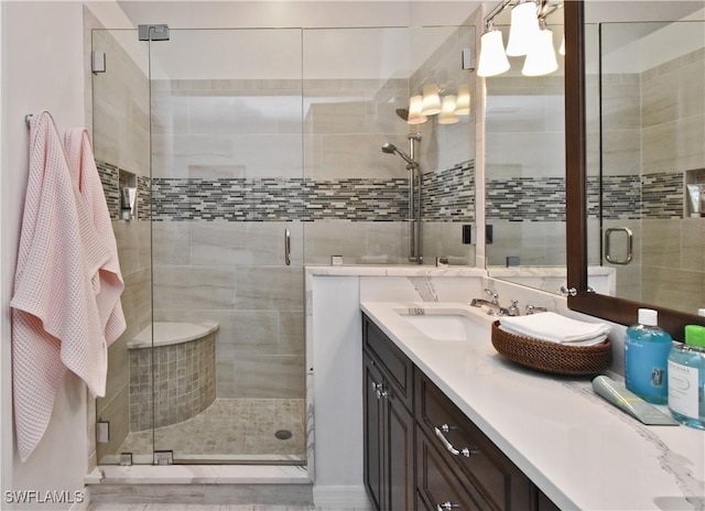 full bath featuring a stall shower and vanity