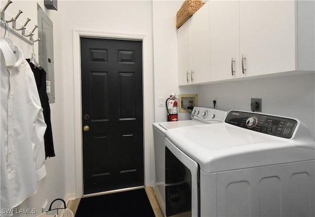 clothes washing area with independent washer and dryer and cabinet space