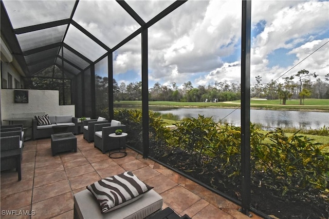 view of patio / terrace featuring a lanai, a water view, and an outdoor living space