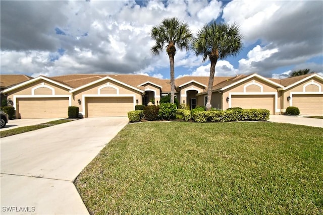 ranch-style home with a front yard, concrete driveway, an attached garage, and stucco siding