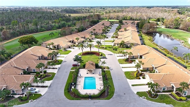 drone / aerial view with a water view and a residential view