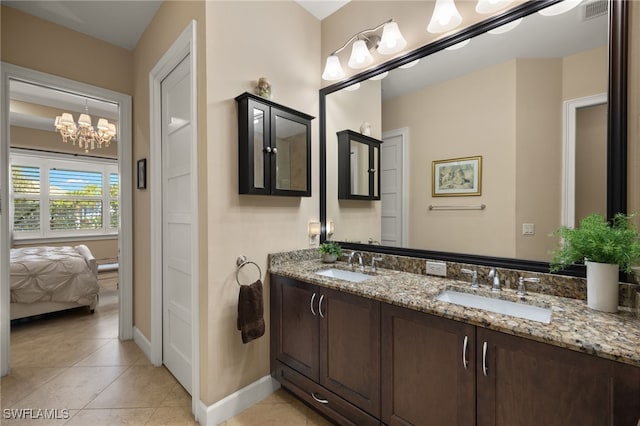 bathroom with vanity, tile patterned flooring, and a notable chandelier