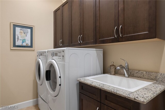 washroom featuring cabinets, separate washer and dryer, and sink