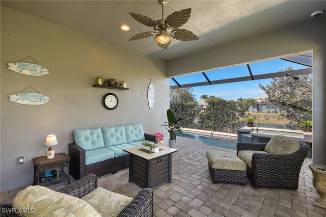 view of patio / terrace featuring a lanai, outdoor lounge area, and ceiling fan