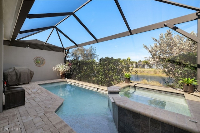 view of pool with a grill, a lanai, a patio, and an in ground hot tub