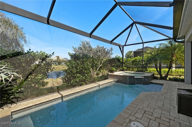 view of swimming pool with an in ground hot tub, a water view, a patio, and glass enclosure