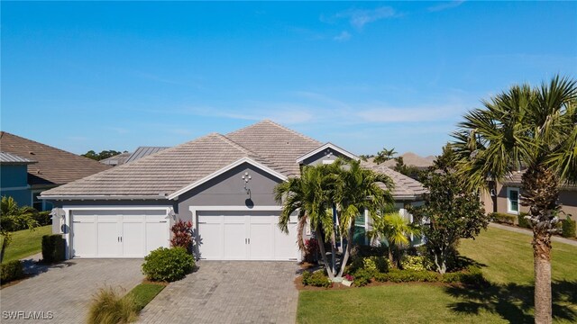 view of front of property featuring a garage and a front lawn