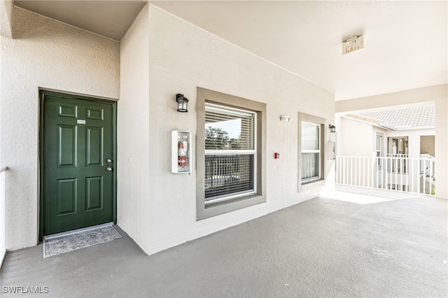 view of exterior entry featuring covered porch