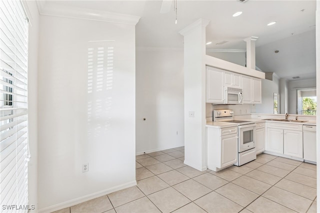 kitchen with white cabinets, crown molding, vaulted ceiling, white appliances, and light tile patterned floors