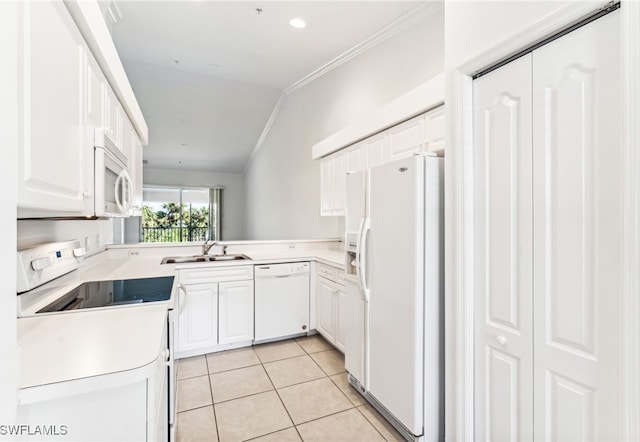 kitchen with sink, light tile patterned floors, lofted ceiling, white appliances, and white cabinets