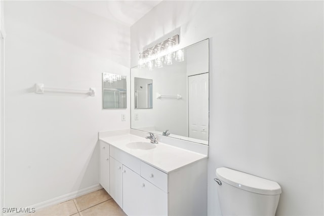 bathroom featuring tile patterned floors, vanity, and toilet