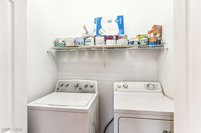 washroom featuring washing machine and clothes dryer