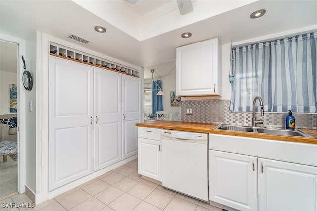 kitchen with decorative backsplash, wooden counters, white dishwasher, sink, and white cabinetry