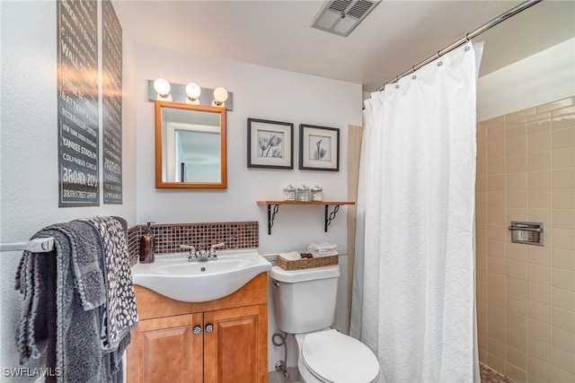 bathroom with a shower with shower curtain, vanity, and toilet