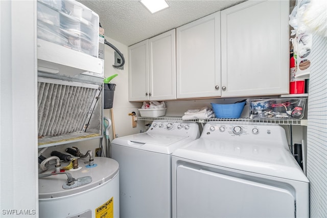 laundry room featuring washing machine and dryer, electric water heater, cabinets, and a textured ceiling