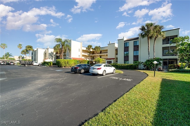 view of parking featuring a yard