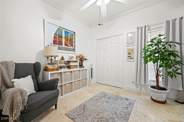 entrance foyer featuring ceiling fan and ornamental molding